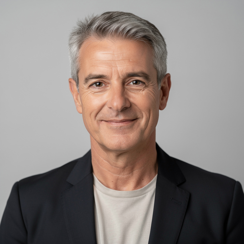 Studio portrait of a middle-aged man with grey hair